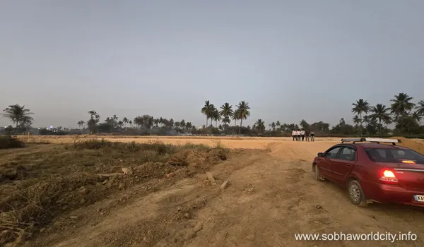 Construction site progress and infrastructure leveling at Sobha World City in Hoskote.